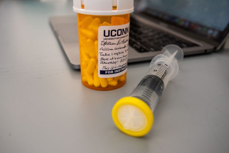 Medication, syringe, and laptop