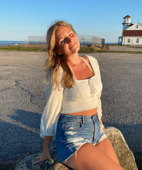 Chesney smiling near a lighthouse