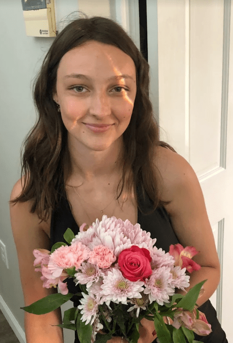 Erin Warner holding a bouquet of flowers